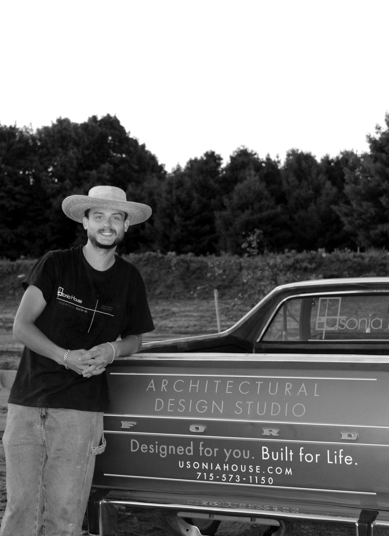 Dylan Groshek beside the Usonia House Ranchero on a job site.